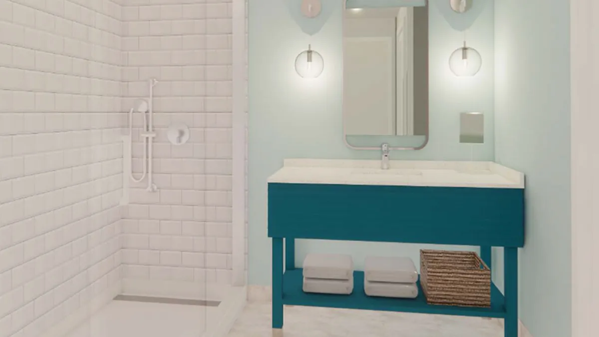 A modern bathroom featuring a stylish teal vanity, a glass-enclosed shower, contemporary light fixtures, and plush towels. The space feels fresh, clean, and designed for relaxation and personal routines.